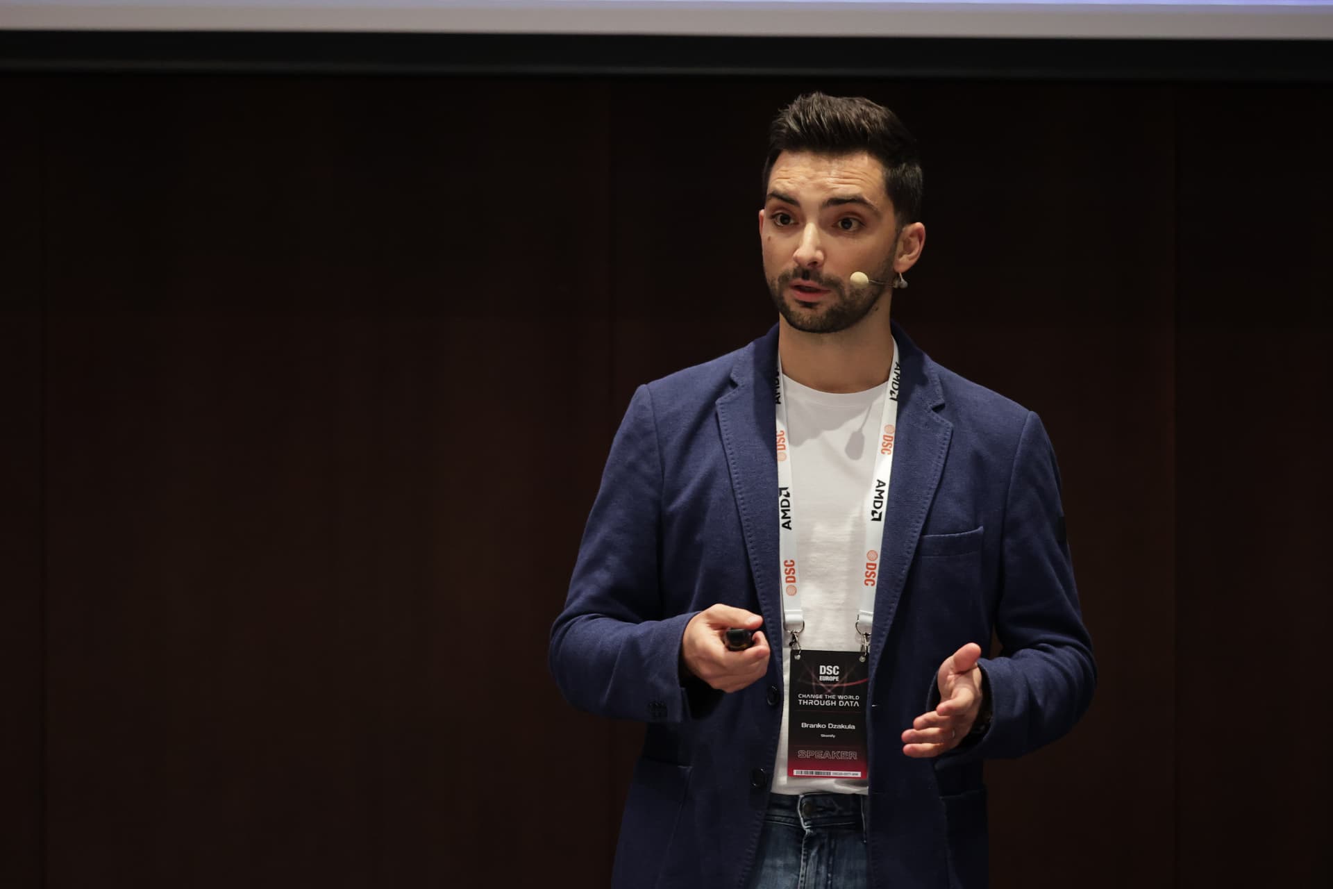 Branko Džakula on stage with a headset microphone at DSC Europe.