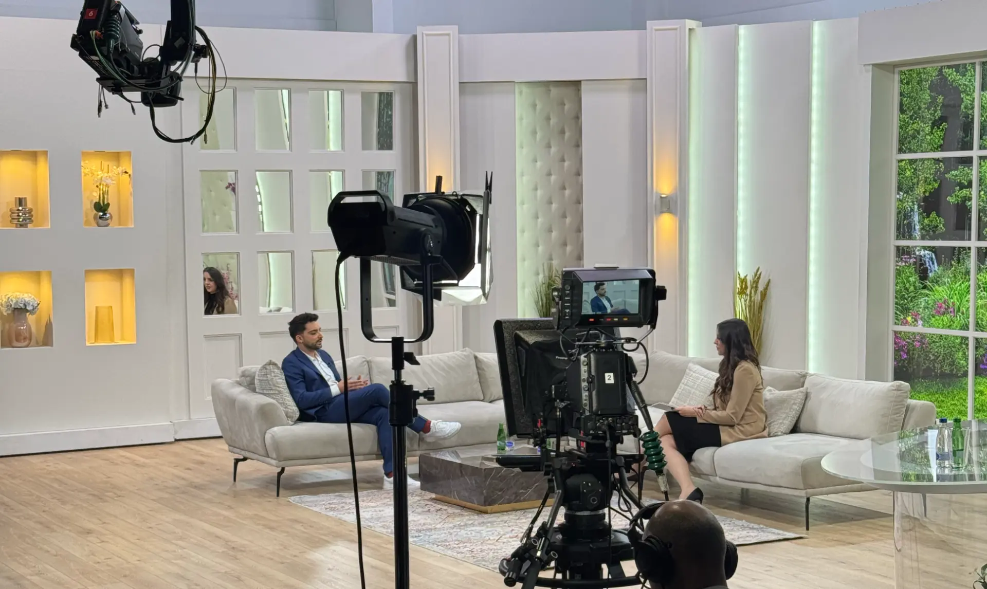 Wide view of a television studio set during a live interview